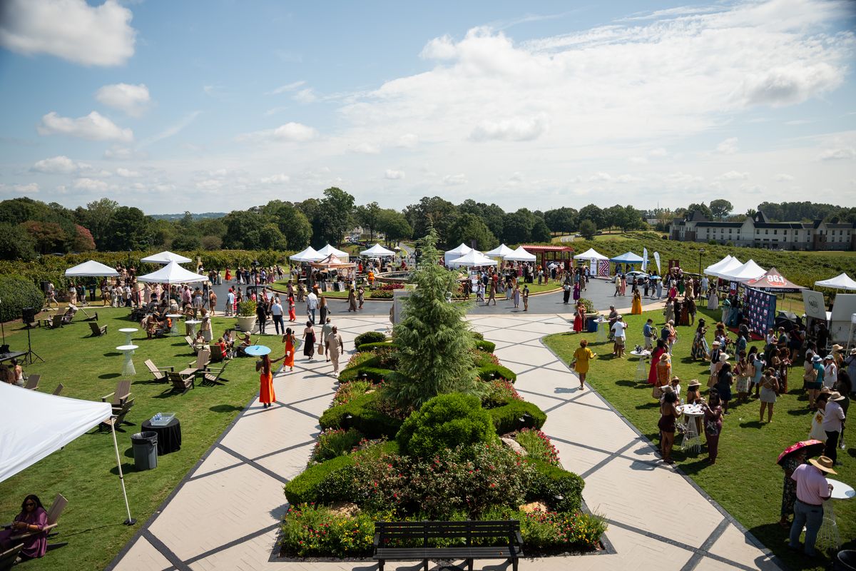 Festival crowd spread across the Château Élan lawn, seen from above